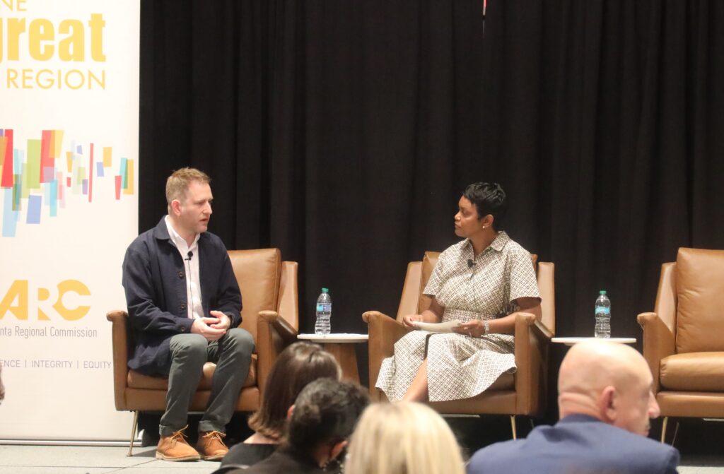ARC Executive Director & CEO Anna Roach talks with author Brian Goldstone at ARC's Regional Housing Summit