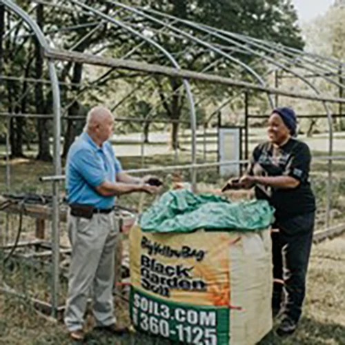 Personnel from the Austell Local Food Task Force collecting donations in large box.