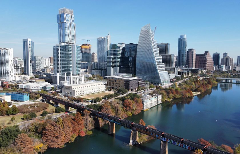 View of downtown Austin skyscrapers beside Lady Bird Lake.