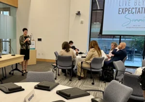 Becky Kurtz presenting to a group of people about Live Beyond Expectations.