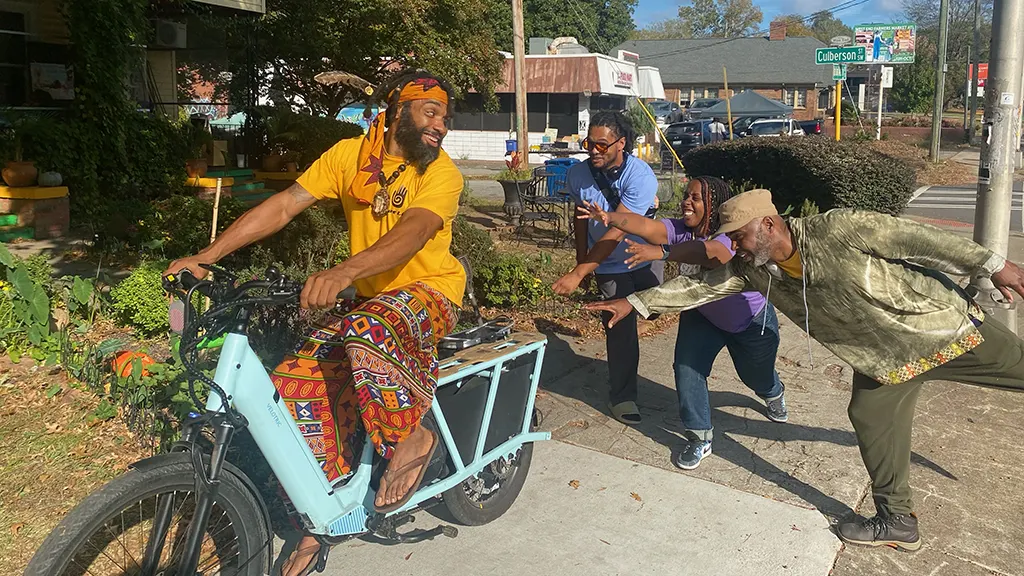 Guy on an e-bike with three admirers
