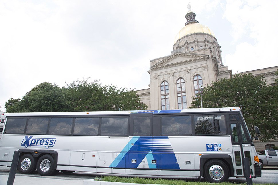 A Xpress bus in front of the Georgia State Capital