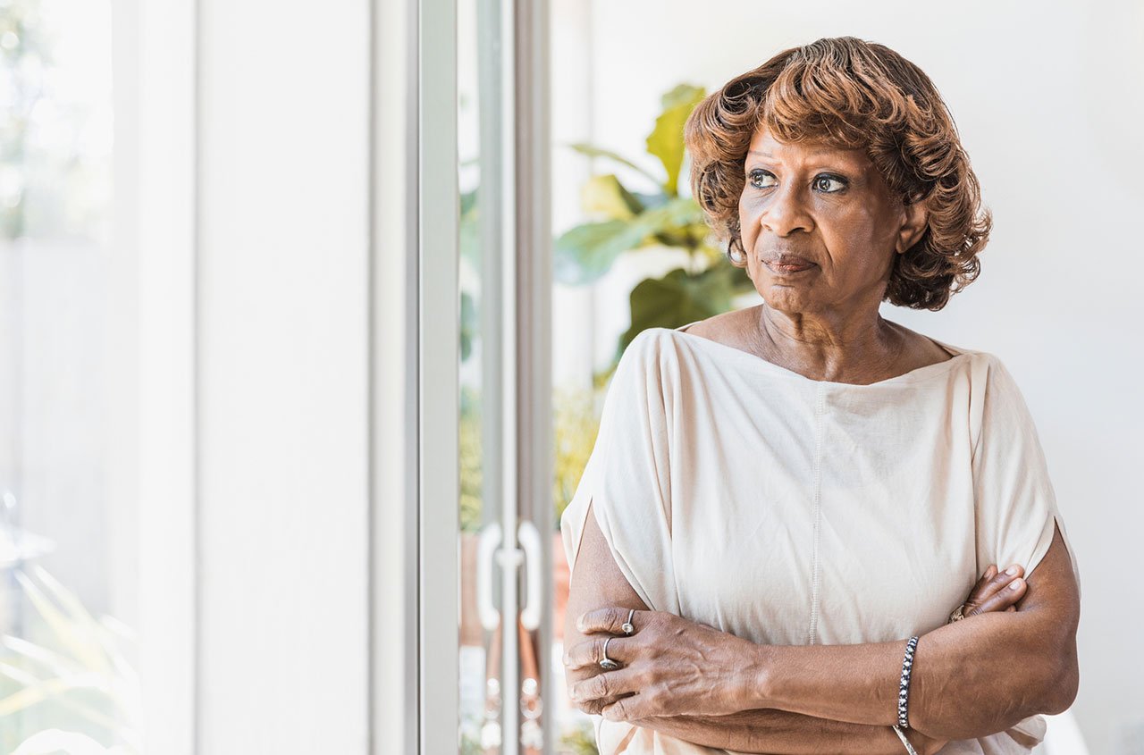 Older woman looks out of window