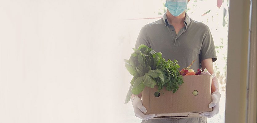 Man holding a box of produce