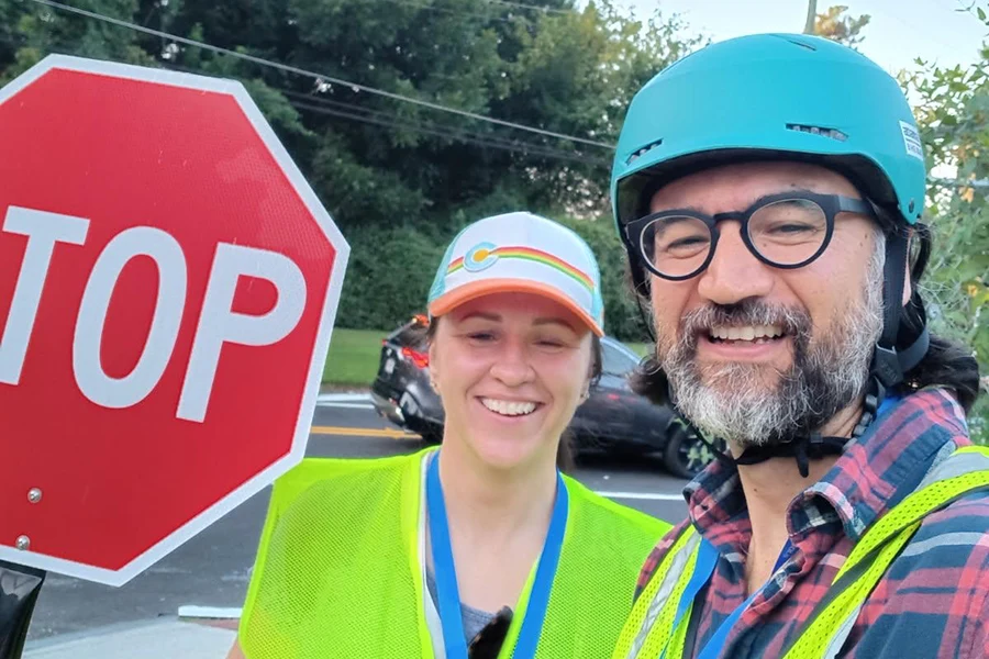 Crossing guard and bike-bus parent posed for a picture.