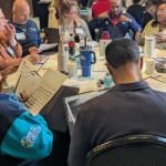 RLI members seated at a table participating in a group activity