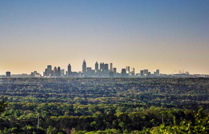 View of Atlanta skyline in the distance with trees in foreground